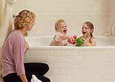 A young mom gives her kids a bubble bath powered by a KOHLER generator