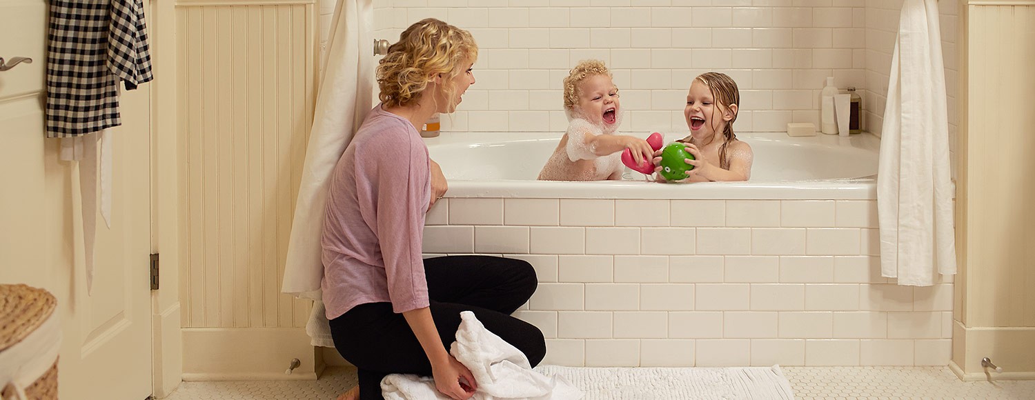 A young mom gives her kids a bubble bath powered by a KOHLER generator. 