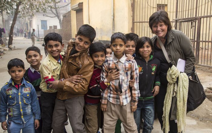 Cindy Howley stands in the street with a group of children