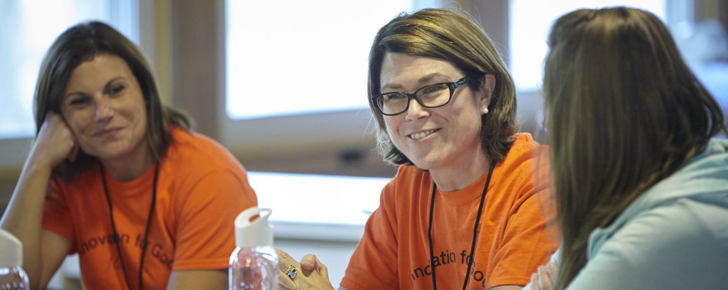 Brigitte Dillman-Cruce, Sustainability Curriculum Manager for Kohler Co. in Kohler, Wisconsin, smiles as she talks with two colleagues
