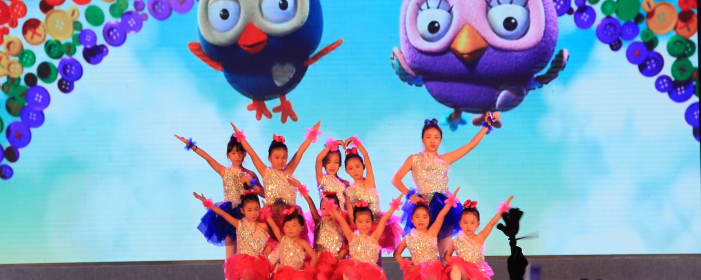 Girls in Zibo, China, wearing dance outfits pose together at a family event