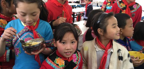 Kids eat at a school in rural China where Kohler China partners with CYDF to donate kitchen equipment, water filtration systems, faucets and sinks
