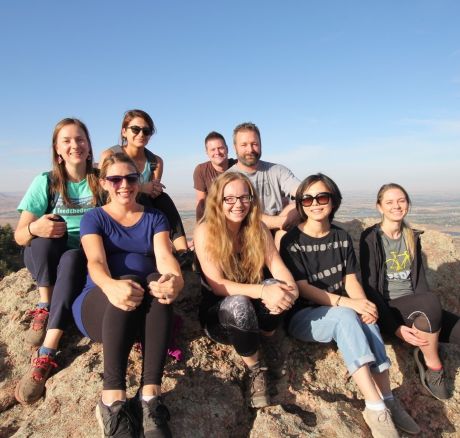 Cher Xue sits on top of a mountain she's just hiked up with a group of other hikers
