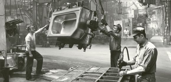 A historic photo of three men in the factory in Kohler, Wisconsin, working on a bath