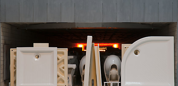 A photo taken from outside shows KOHLER shower bases and baths about to be fired in a giant kiln