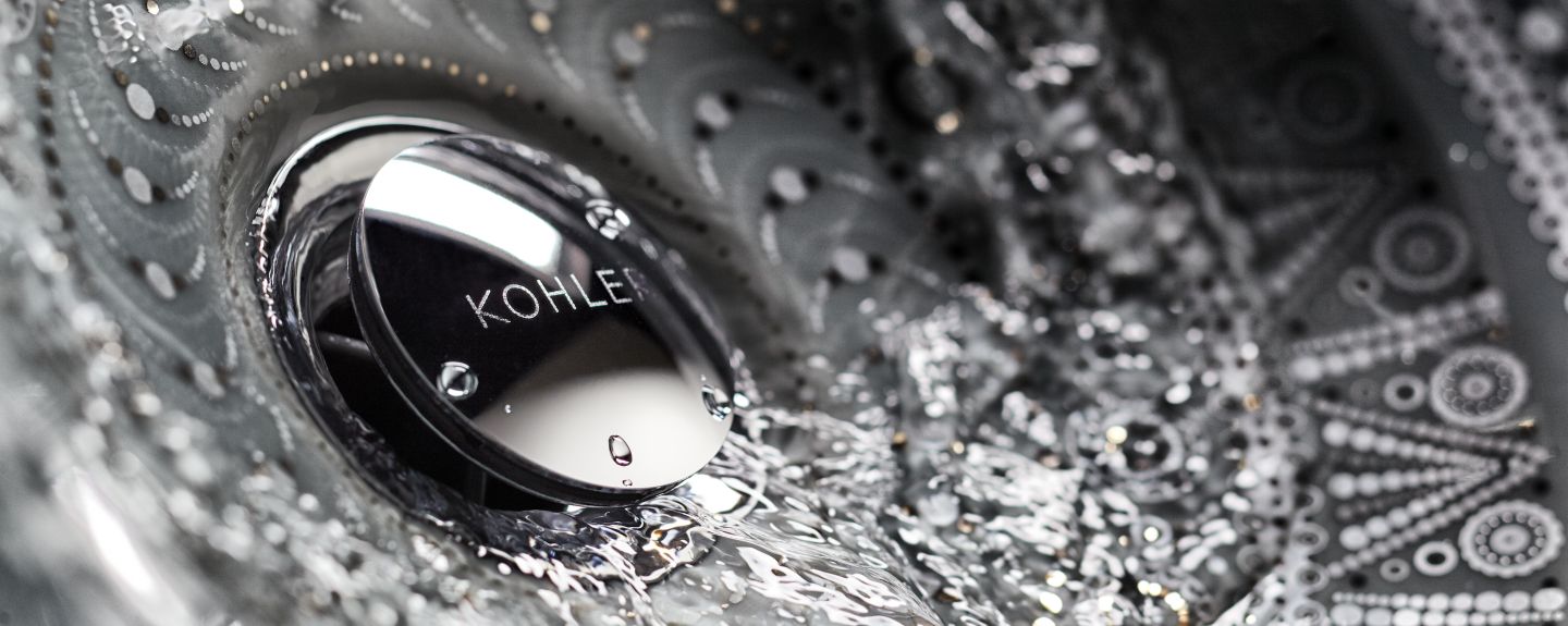 Water flows down the drain of a KOHLER Artist Edition sink.