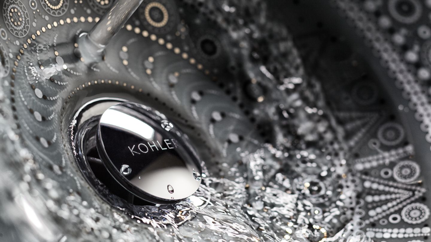 Water flows down the drain of a KOHLER Artist Edition sink.