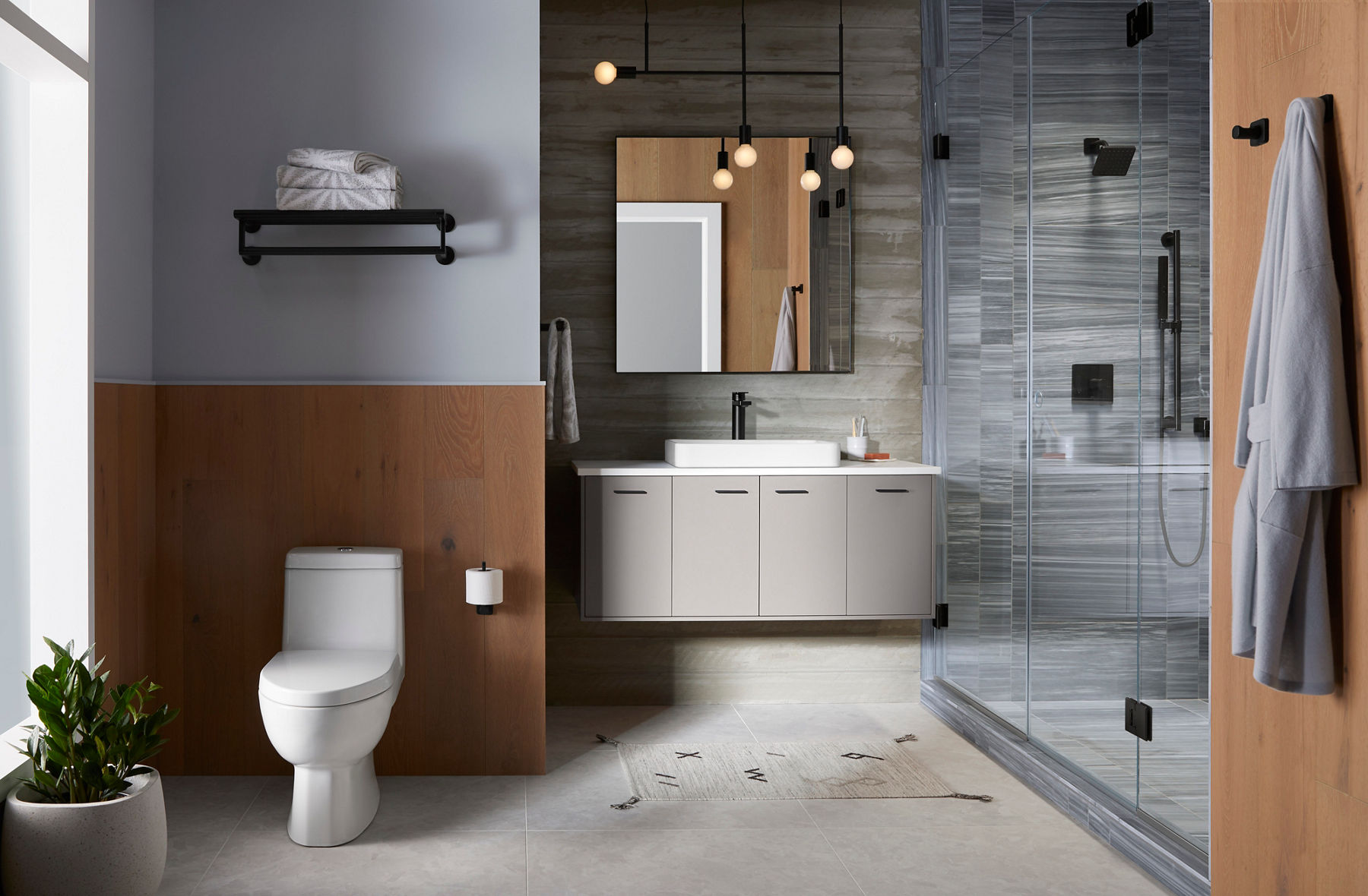 A bathroom in shades of gray and light brown wood with Parallel collection products.