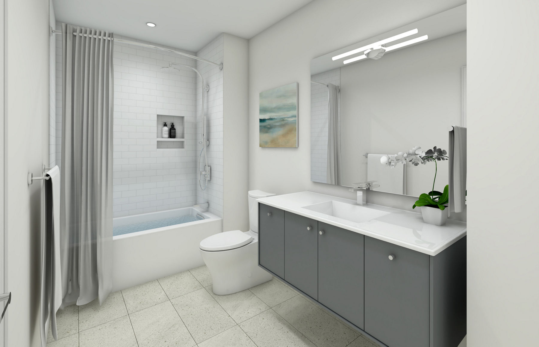 Une salle de bain avec baignoire en alcôve KOHLER blanche, rideau de douche gris, toilette blanche, meuble-lavabo mural gris, dessus de meuble-lavabo blanc et grand miroir avec appliques.
