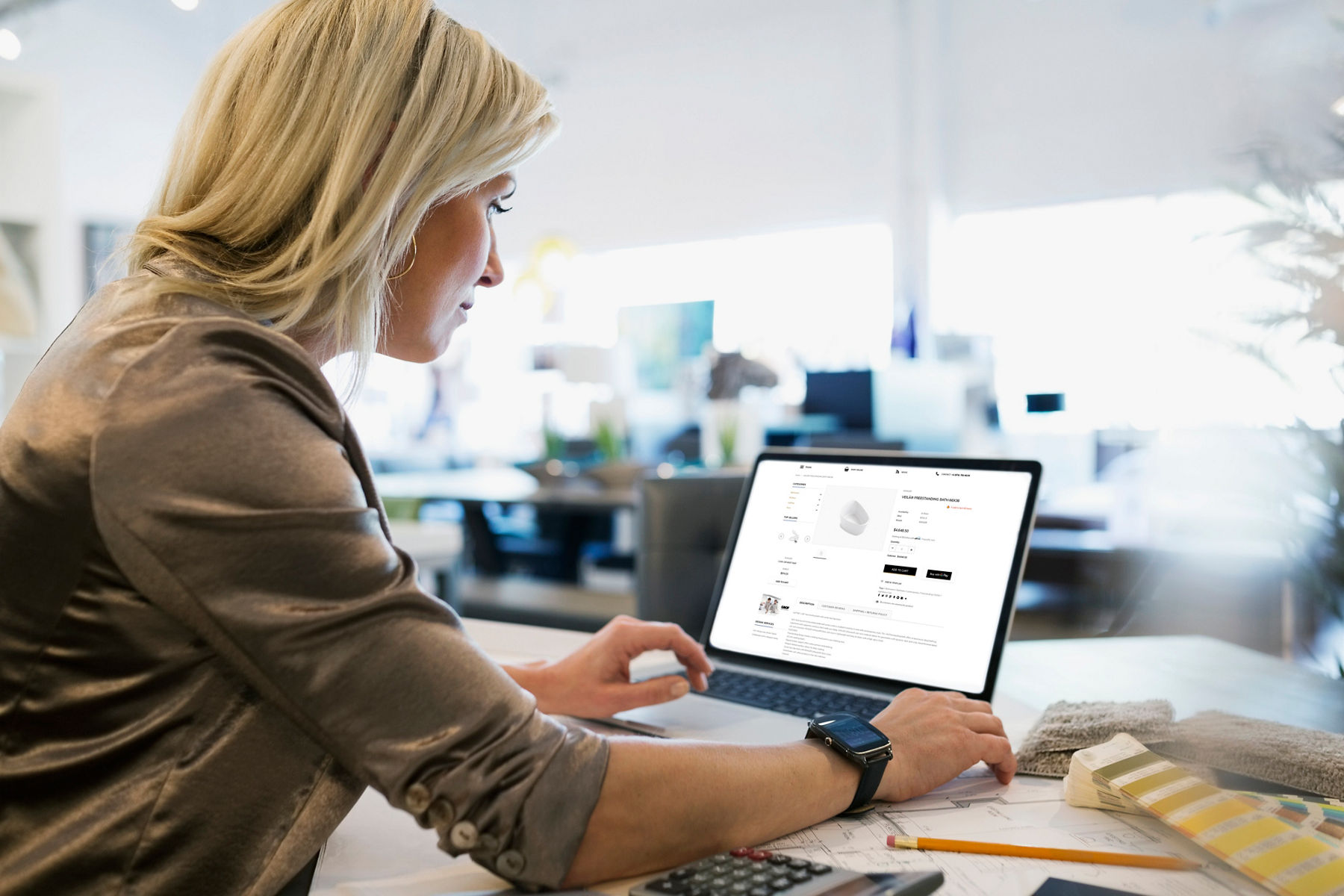 Two hands at a laptop computer with a product support page on the screen.