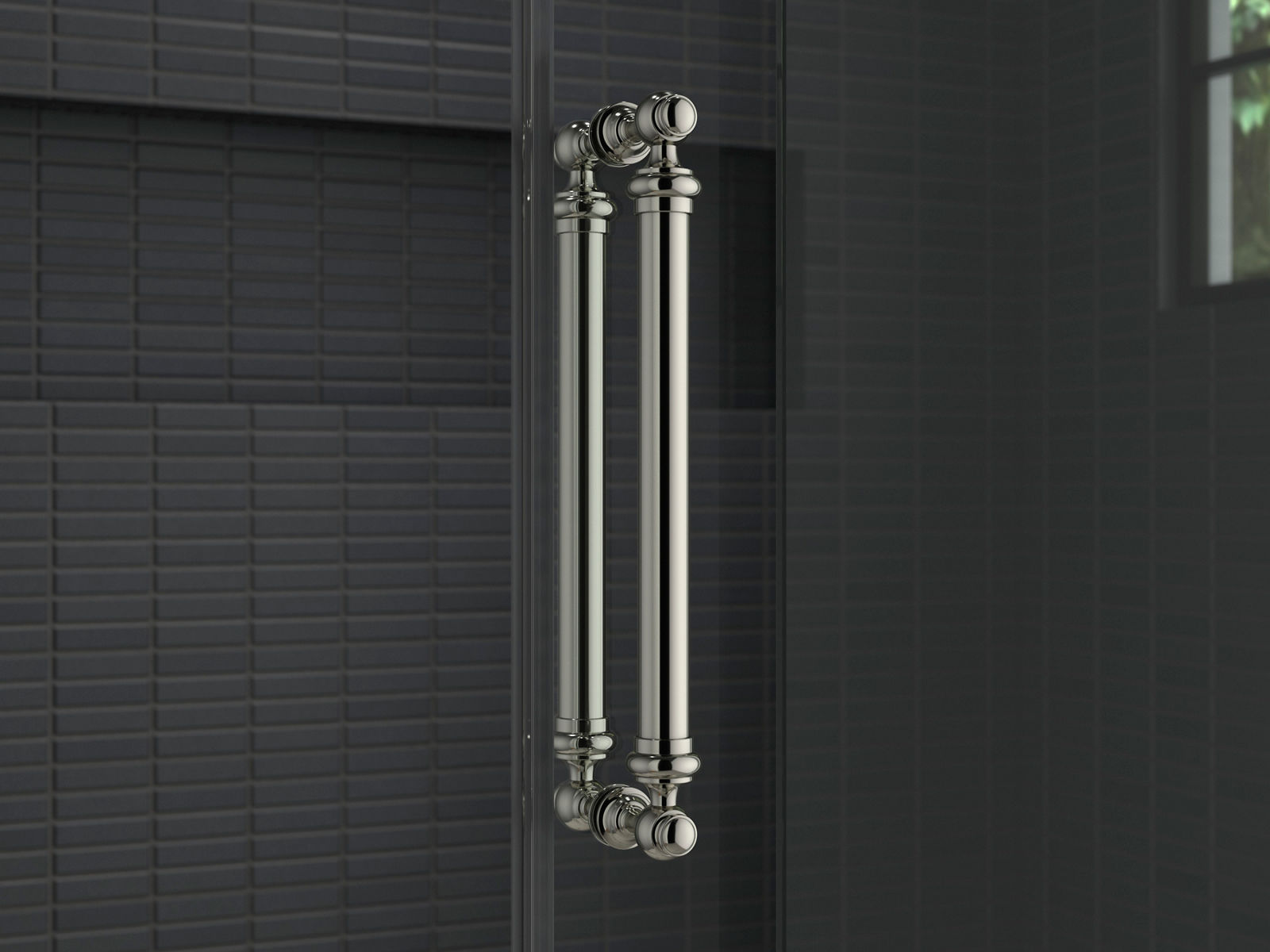A glass shower door with a traditional style handle in polished chrome.