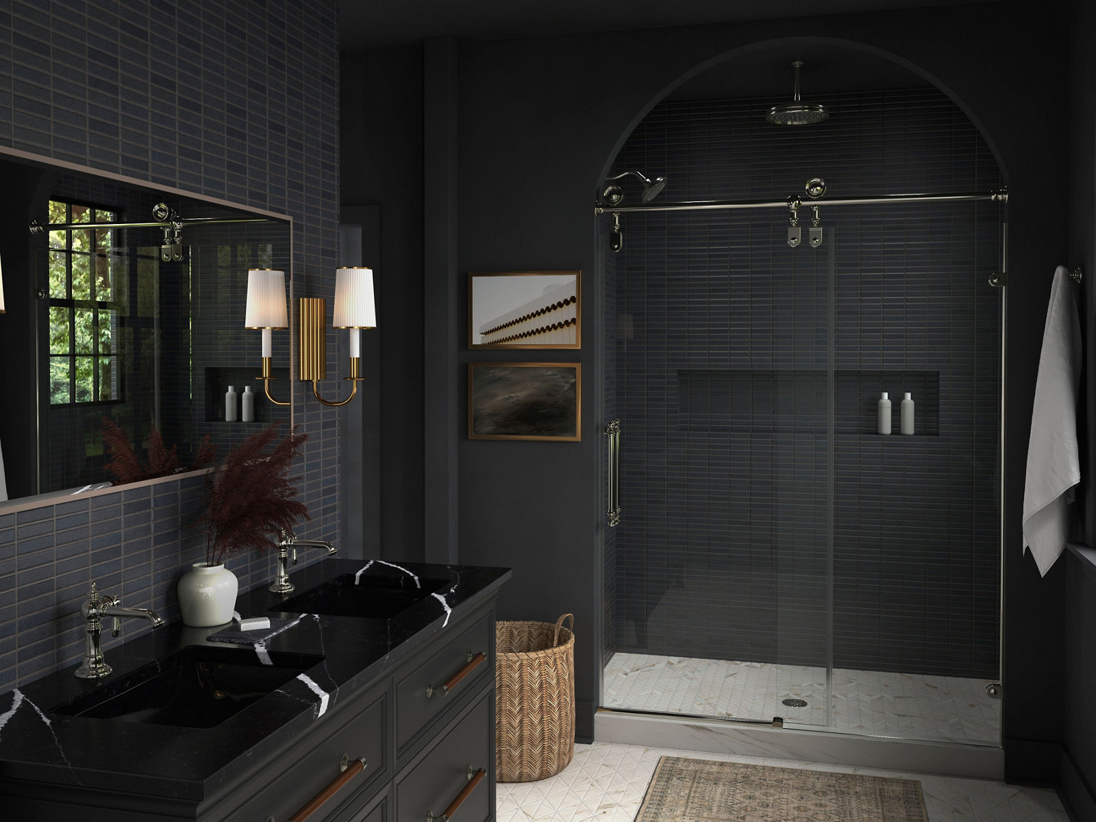 A double vanity area with a black stone counter top with white veining and polished chrome traditional faucets.