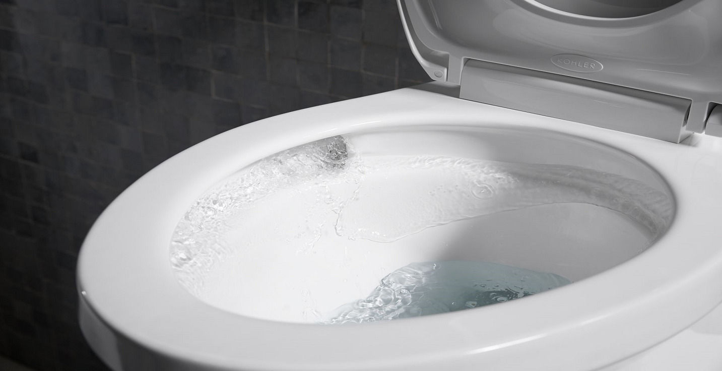 Smart toilet with open lid showcasing water flow inside the bowl, indicating flushing in progress.