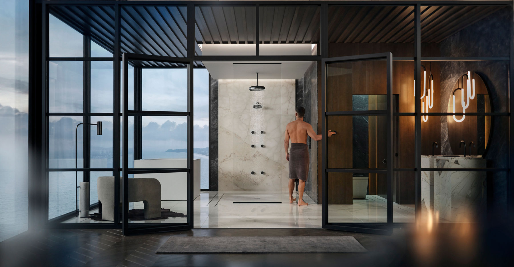 Image du design de la salle de bain Lavish Moods avec un système de douche en verre massif moderne et un homme debout dans sa serviette, utilisant les jets corporels pour préparer sa douche.