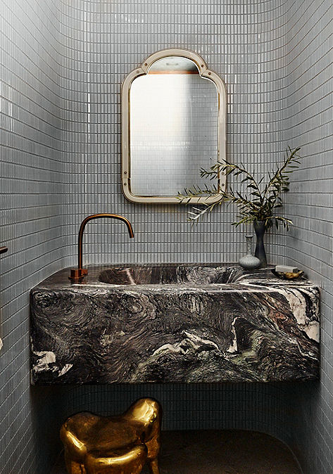 Modern bathroom interior vanity with Ann Sacks wall tile and marble countertop.