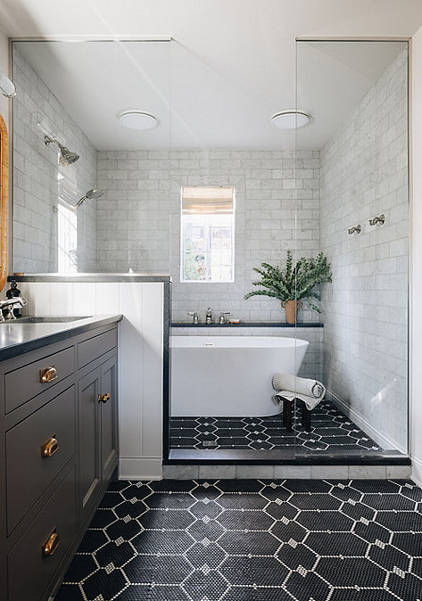 Modern bathroom interior with Ann Sacks black floor tile and white shower tile.