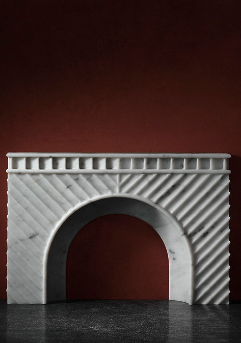 White marble fireplace with moody red background.