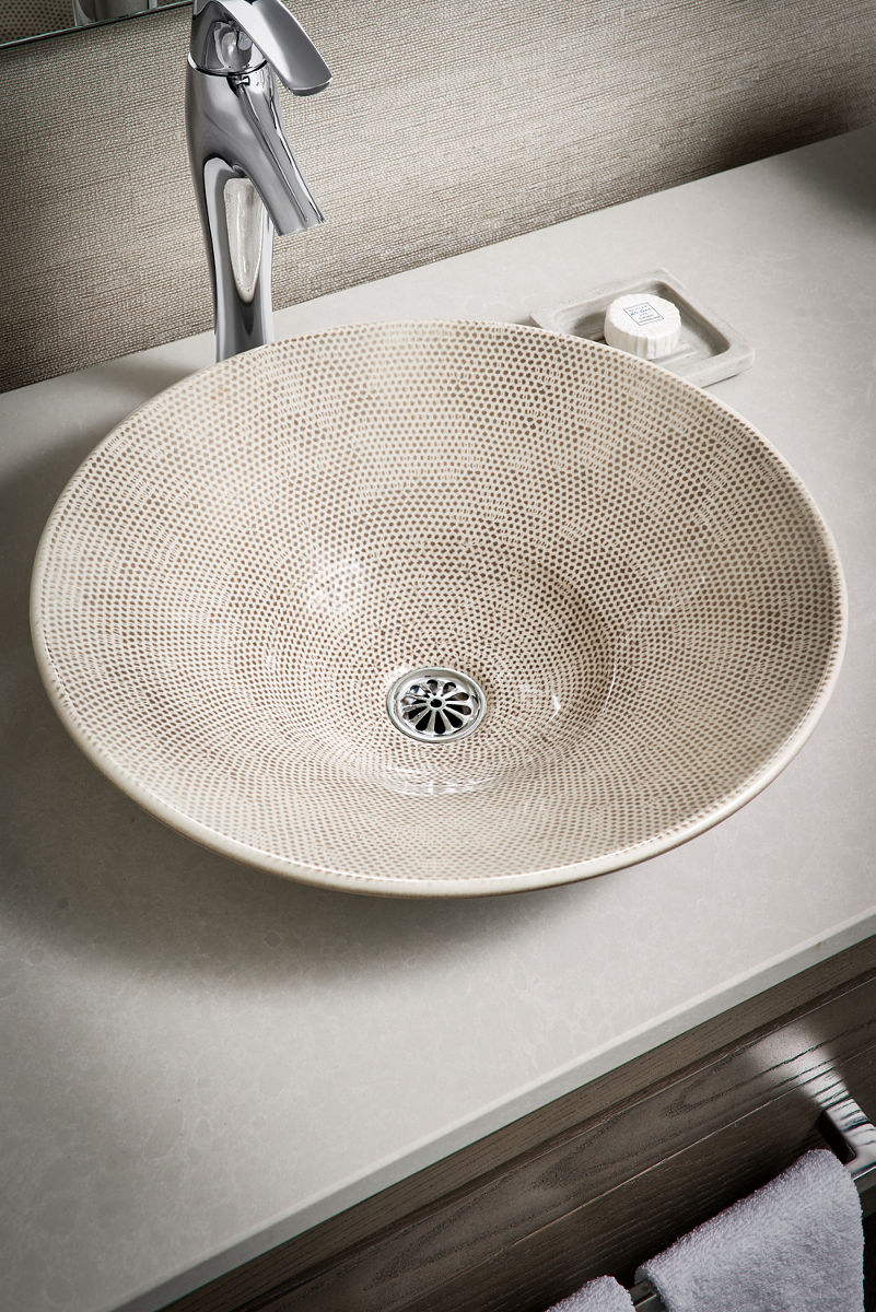 Aerial view of vessel sink paired with tall bathroom sink faucet.