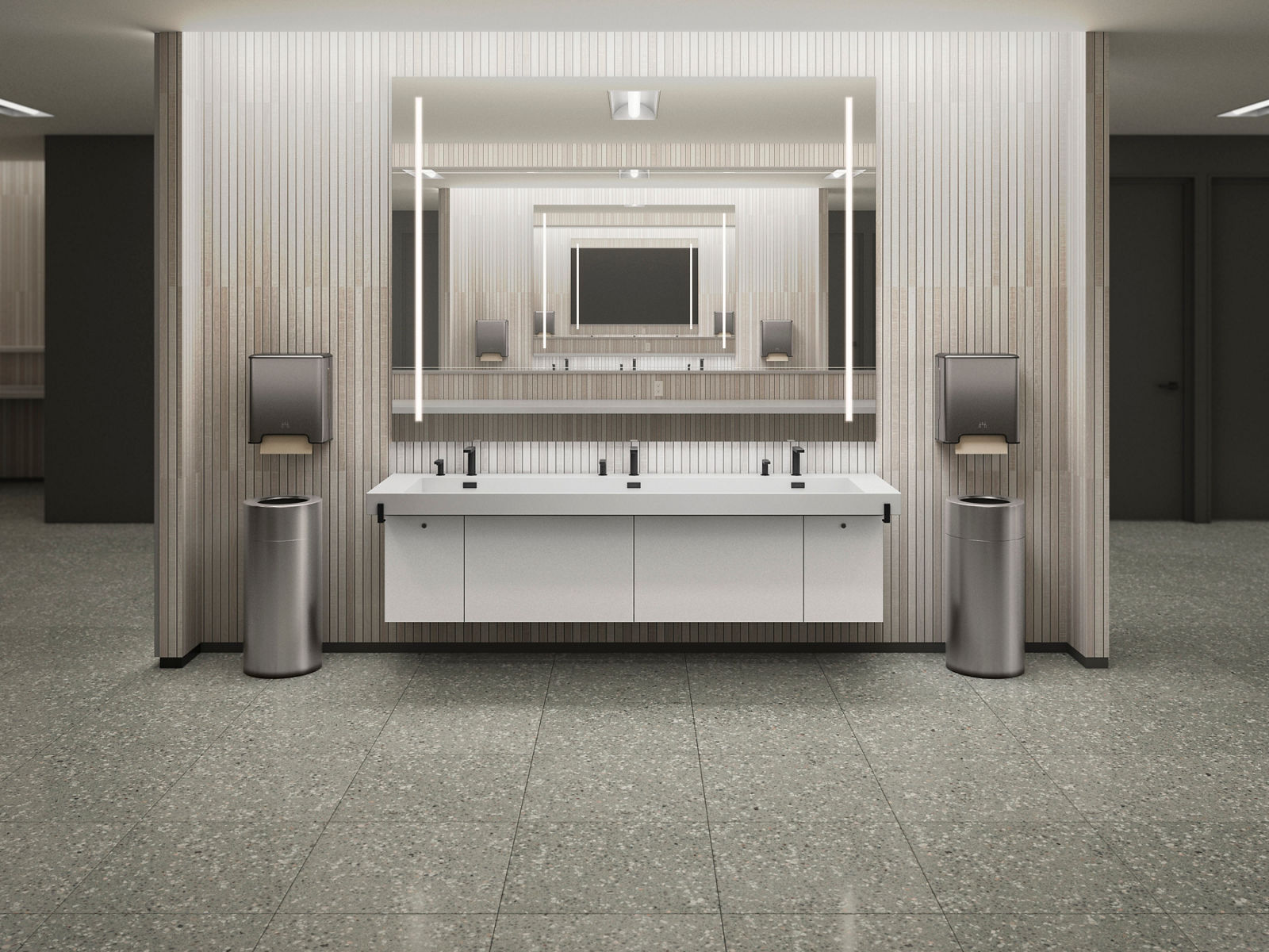 A large vanity with three basins, a white countertop, and industrial-modern lighting, ideal for spacious commercial bathrooms.