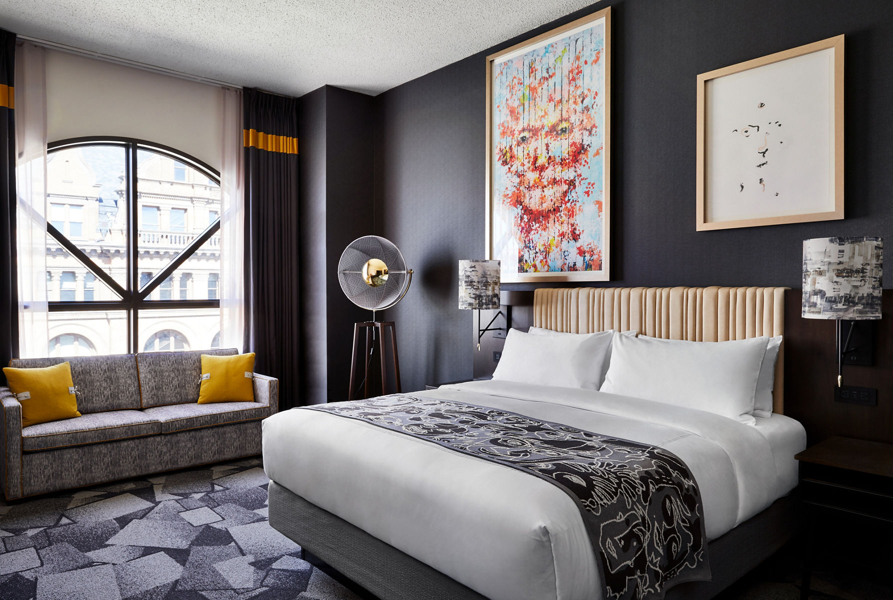 A photo of one of the hotels ecclectic guest suites featuring colorful accents and abstract wall decor.