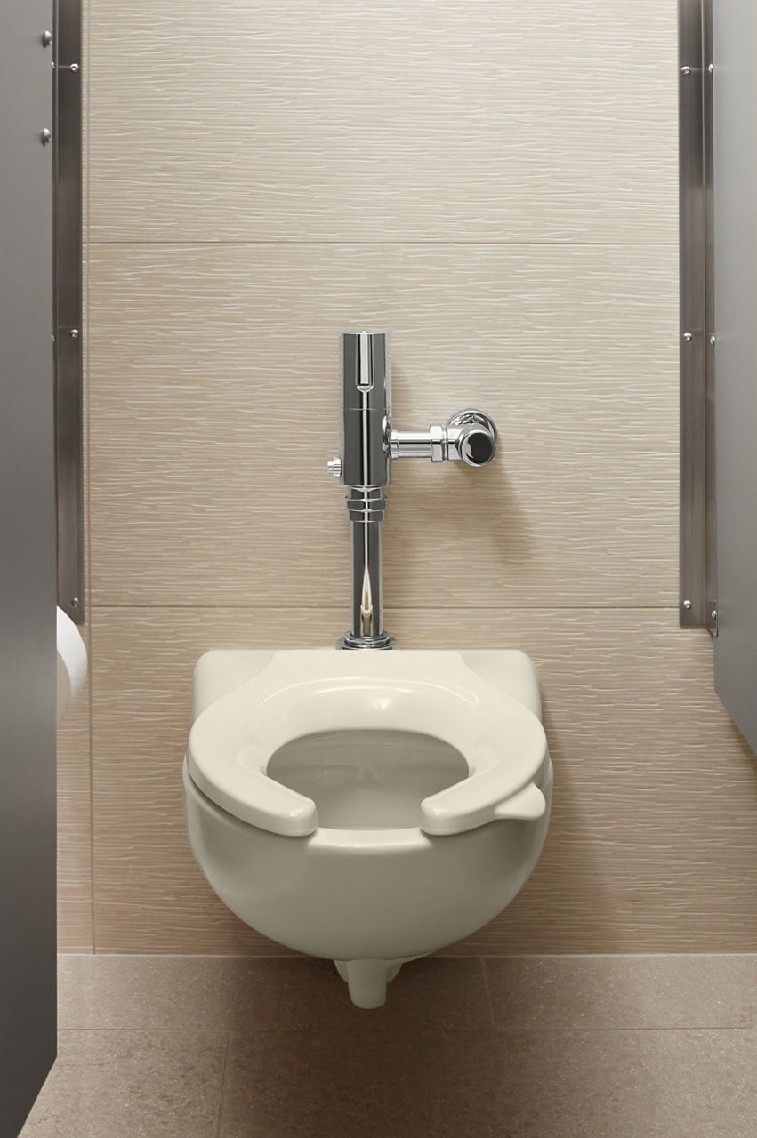 A stall with a KOHLER Stronghold toilet seat on a Kingston wall-mounted toilet bowl.