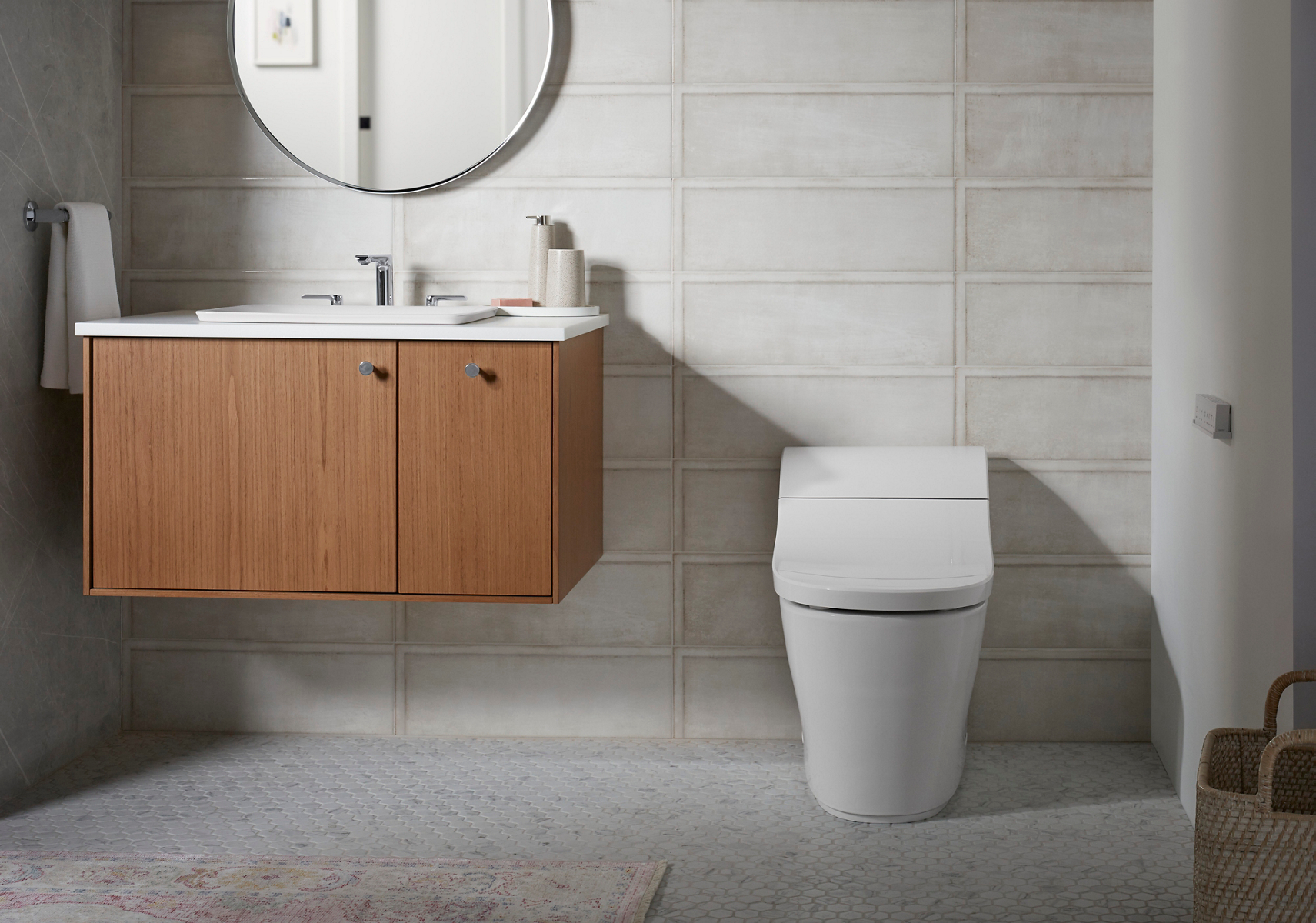 A close up sunlit shot of a white one-piece toilet with the lid shut in a white tiled bathroom.