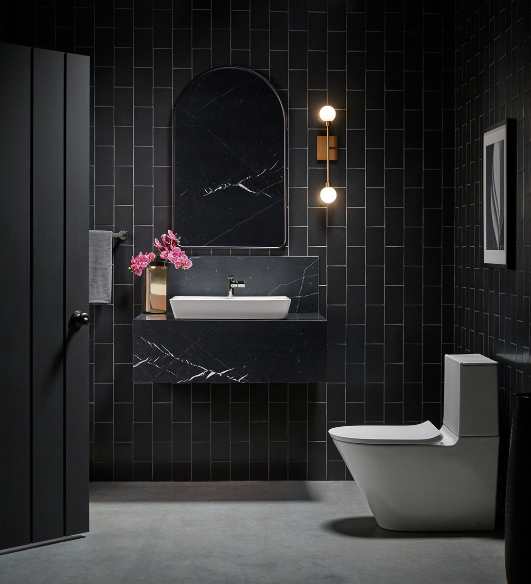 A opulent bathroom in brushed brass, soft greens and matte black with Occasion collection products.