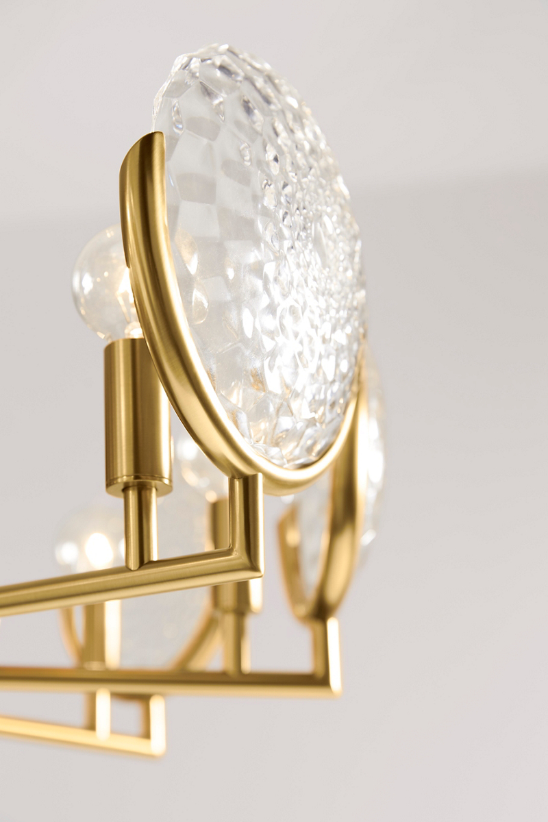 A detail view of the faceted crystals in front of clear bulbs on a KOHLER Arendela chandelier.