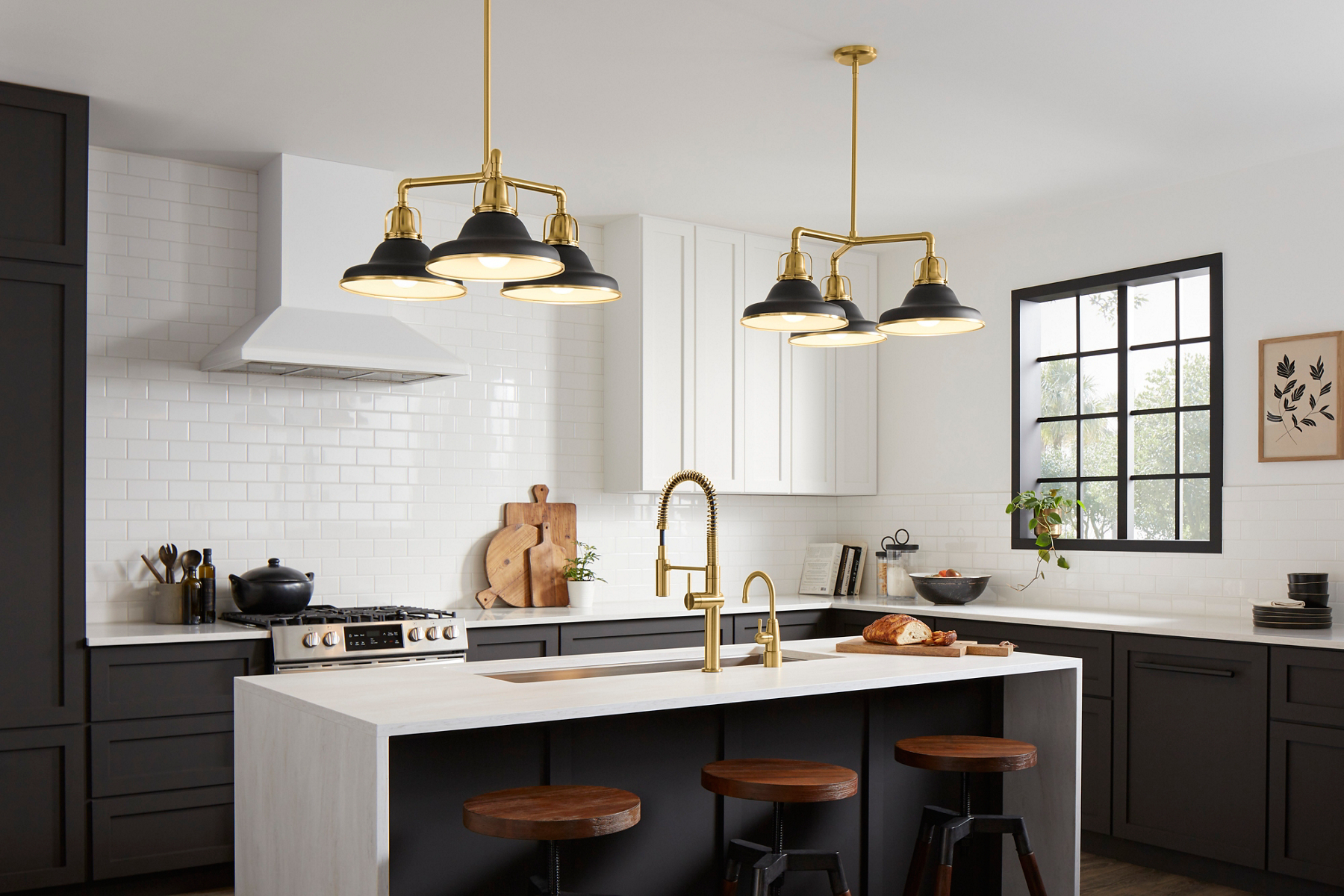 A kitchen in white and deep blue with brushed brass Crue collection faucets.