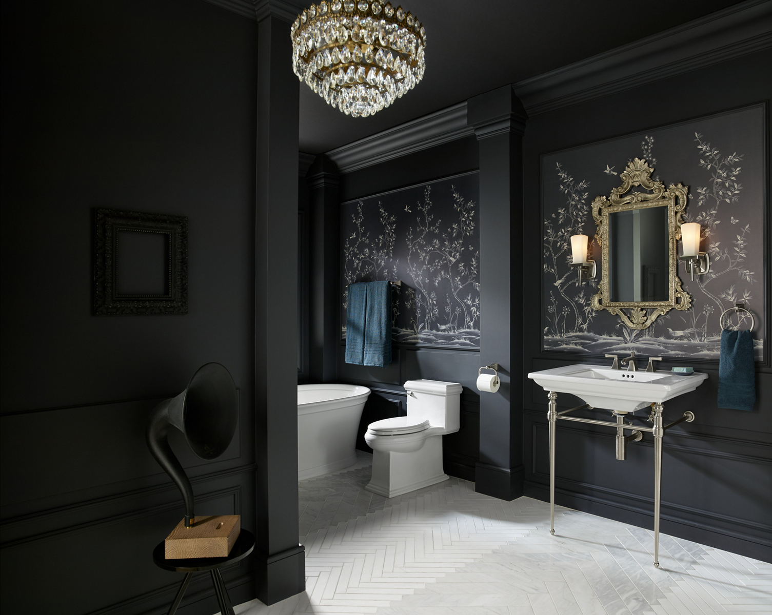 An ornate traditional bathroom in dark gray hues with brushed nickel hardware and white Memoirs collection products.